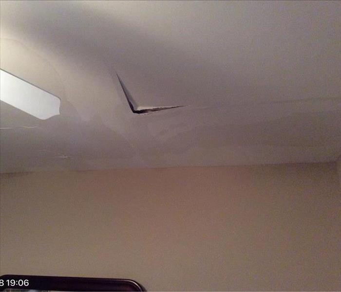 hanging water damage ceiling by a fan