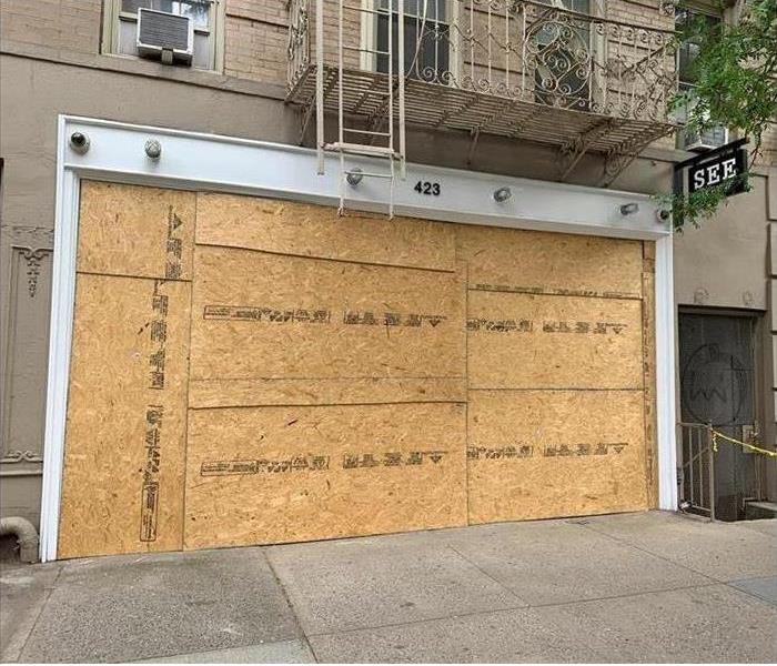 Store with boarded up front window  