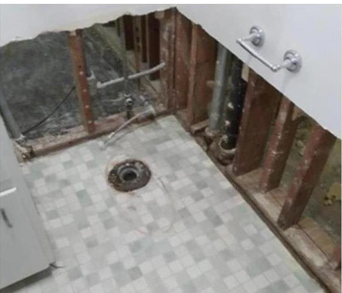 Bathroom with outtake pipe visible and opened walls