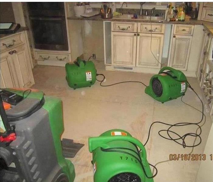 Kitchen with SERVPRO air movers and dehumidifier